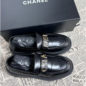 CHANEL Black Leather Loafers with Gold Accents